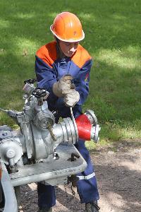 Bild: Der Maschinist beim Arbeiten an der Pumpe eines L&amp;ouml;schfahrzeugs