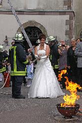 Bild: Die Braut beim Löschen des Brandes mit einer Kübelspritze